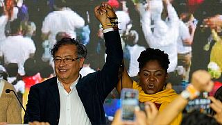 Presidential candidate Gustavo Petro, left, and his running mate Francia Marquez stand before supporters on election night in Bogota, Colombia, Sunday, May 29, 2022.