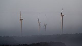 Wind turbines stand outside the village of Nazare, on the west coast of Portugal, Sunday, Dec. 22, 2019.