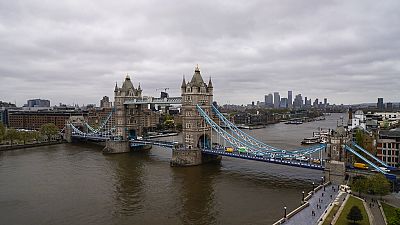 Tower Bridge in London, Saturday, May 8, 2021, against the backdrop of the skyline of the financial district. 