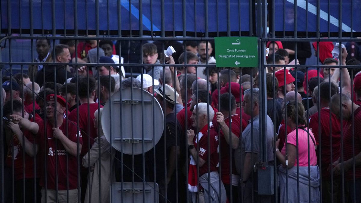 Fans wait in front of the Stade de France prior the Champions League final soccer match between Liverpool and Real Madrid, in Saint Denis near Paris, Saturday, May 28, 2022.