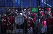 Fans wait in front of the Stade de France prior the Champions League final soccer match between Liverpool and Real Madrid, in Saint Denis near Paris, Saturday, May 28, 2022.