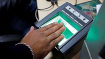 File: A woman scans her finger for the Unique Identification (UID) database system, also known as Aadhaar, at a registration centre in New Delhi, India, January 17, 2018. 