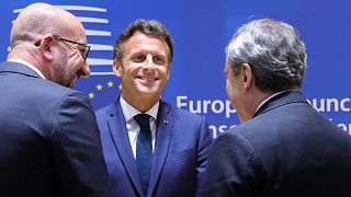 French President Emmanuel Macron (C), EU Council President Charles Michel (L) and Italian Premier Mario Draghi talk at a Council summit in Brussels, May 30, 2022.