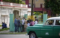 Diplomats from several countries wait outside the court building where a trial is going on for Cuban artists Luis Manuel Otero Alcantara and Maykel Castillo in Havana, Cuba, M