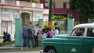 Diplomats from several countries wait outside the court building where a trial is going on for Cuban artists Luis Manuel Otero Alcantara and Maykel Castillo in Havana, Cuba, M