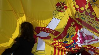 A woman holds a Spanish flag in Madrid on 23 October 2020