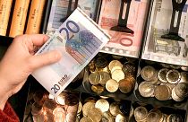 Euro coins and banknotes are pictured in a shop in Duisburg, Germany, Dec. 29, 2001. 