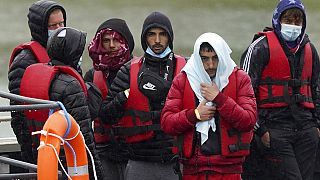 A group of people thought to be migrants are brought in to Dover, Kent, following a small boat incident in the Channel, England, Monday May 23, 2022.