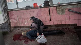 Nach einem Bombenangriff auf Charkiw: Eine Frau kniet neben ihrem toten Ehemann.