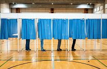 People vote at Rude Skov School in Birkeroed, Denmark, Wednesday June 1, 2022.