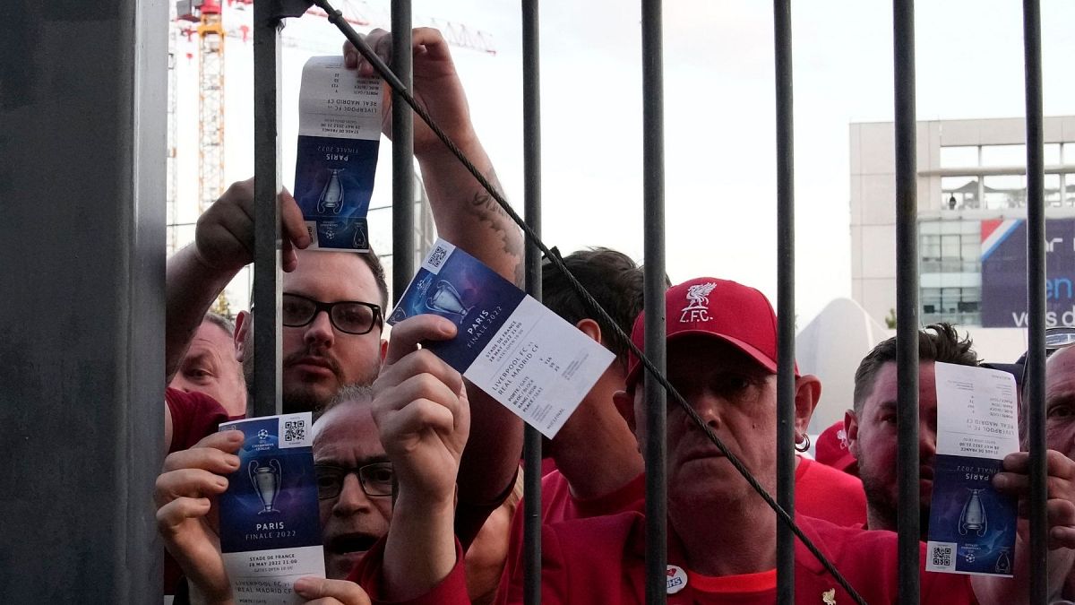 Fans shows tickets in front of the Stade de France prior the Champions League final soccer match between Liverpool and Real Madrid, in Saint Denis near Paris, 28 May 2022