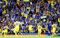Ukraine's Roman Yaremchuk, center, celebrates after scoring his side's second goal during the World Cup 2022 qualifying play-off soccer match between Scotland and Ukraine. 