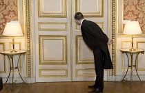 A usher looks through the key hole at the French foreign ministry in Paris, Friday March 4, 2016