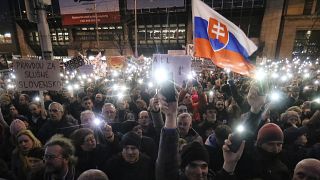 FILE- In this Friday, March 9, 2018, file picture demonstrators light the torches of their smartphones during an anti-government rally in Bratislava, Slovakia.
