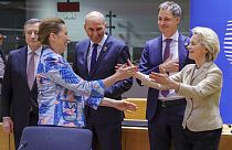 European Commission President Ursula von der Leyen, right, and Denmark's Prime Minister Mette Frederiksen greet each other on Tuesday