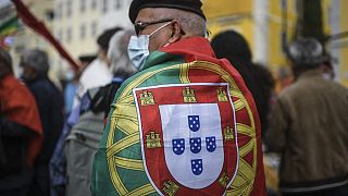 A Portuguese man carries a national flag  on October 28, 2021.