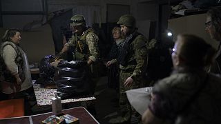 Ukrán rendőrök kenyeret visznek egy földalatti óvóhelyre Szeverodonyeckben