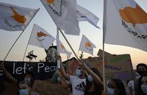 People hold Cyprus flags during a protest against the 47th anniversary of the Turkish invasion on the island, in Dherynia, Cyprus, July 2021
