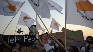 People hold Cyprus flags during a protest against the 47th anniversary of the Turkish invasion on the island, in Dherynia, Cyprus, July 2021