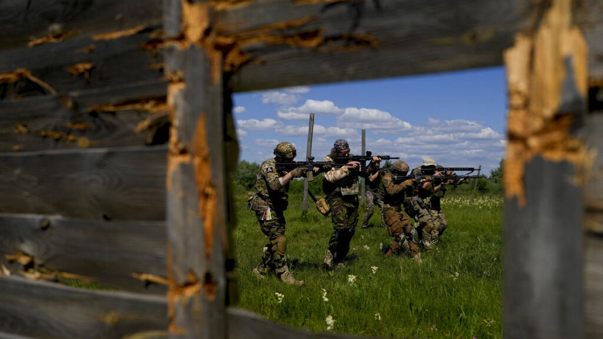 Civilian militia men train at a shooting range in outskirts Kyiv