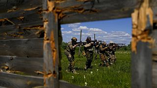 Civilian militia men train at a shooting range in outskirts Kyiv
