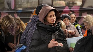 Women, fleeing from Ukraine, stand on a platform at the train station in Przemysl, Poland, Thursday, March 3, 2022