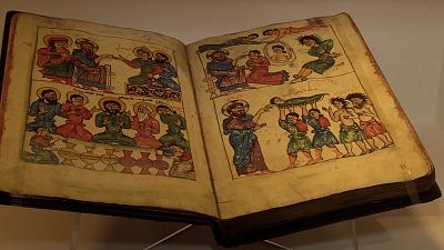 A bible with a depiction of Jesus turning water into wine