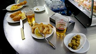 Tapas and beers are served at a restaurant in the Andalusian capital of Seville, southern Spain