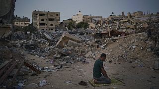 Izrael és a Hamász 11 napos háborújában szétlőtt otthona helyén imádkozik egy palesztin