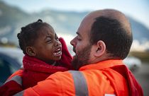 A child is carried by a member of Spain's Maritime Rescue Service as they arrive at the port of San Roque, southern Spain. October 2018