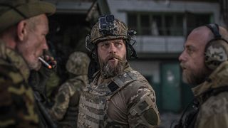 Ukrainian soldiers talk during heavy fighting at the front line in Sievierodonetsk. Wednesday, June 8, 2022.