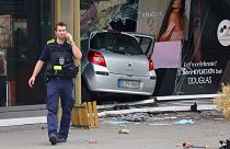 A car is seen in a shop window after crashing into a group of people near Breitscheidplatz in Berlin, Germany, June 8, 2022