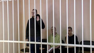 A still image, taken from footage of the Supreme Court of the self-proclaimed Donetsk People's Republic, shows Britons Aiden Aslin, Shaun Pinner and Moroccan Brahim Saadou.
