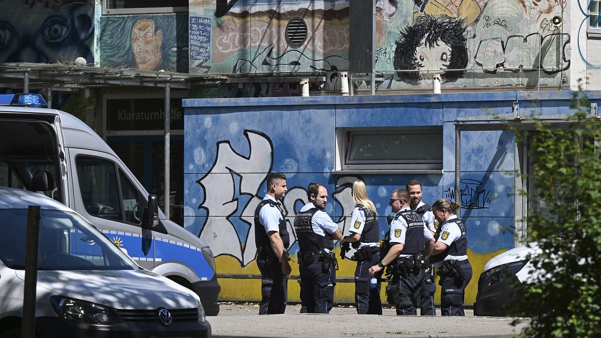 Police officers secure a crime scene in front of a school in Esslingen.