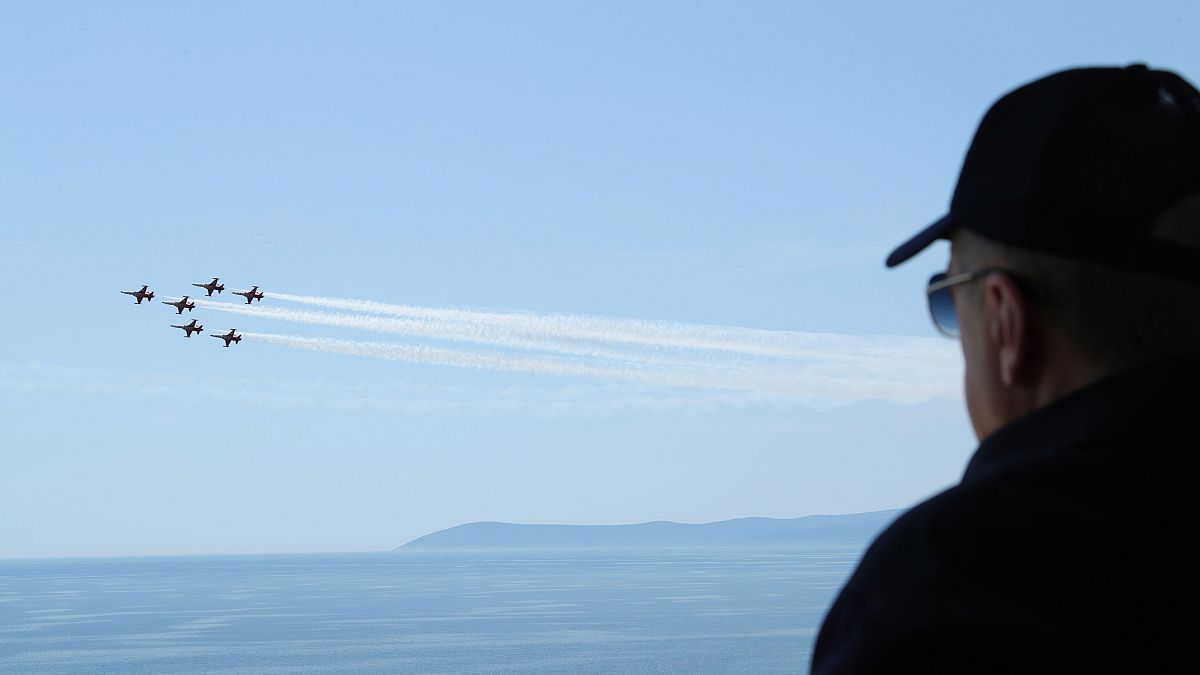 Turkish President Recep Tayyip Erdogan watches jet fighters fly past during the final day of military exercises near Izmir on 9 June 2022