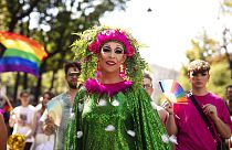 FILE - Participants gather during the annual Gay pride Rainbow Parade, in Vienna, Austria, Saturday, June 11, 2022. (AP Photo/Theresa Wey)