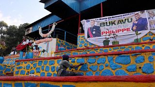 DRC residents repaint buildings for the arrival of the Belgian king