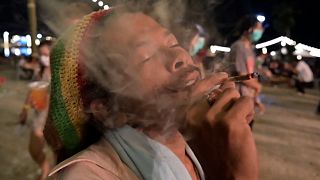 Man smoking cannabis roll at cannabis festival called "Legal Laew"