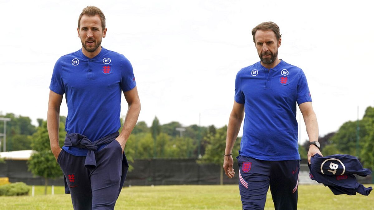 England's Harry Kane, left, walks with manager Gareth Southgate prior to a press conference ahead of Tuesday's UEFA Nations League soccer match