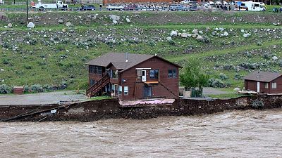 Flooding Yellowstone River undercuts the river bank, threatening a house 