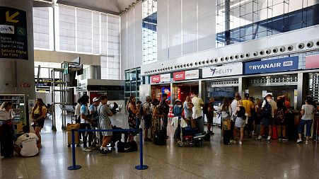 Passengers wait for assistance at Ryanair desk at Malaga-Costa del Sol Airport during the cabin crew strike, in Malaga, Spain, June 30, 2022.