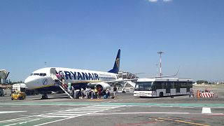 Passengers board a Ryanair plane