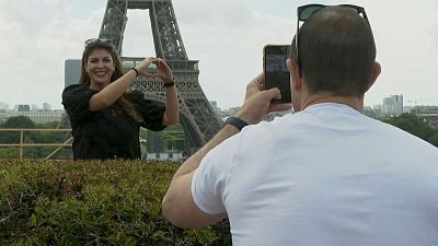 سياح أمام برج إيفل في باريس.