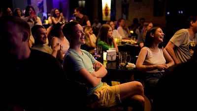 People attend Serhiy Lipko's stand-up comedy show in Kyiv, Ukraine, Saturday, June 11, 2022. 