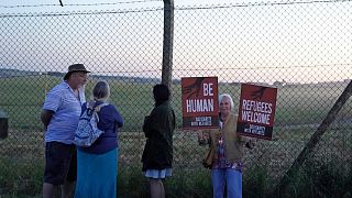 Protesters gather at the perimeter of Boscombe Down air force base in Amesbury, England on Tuesday June 14, 2022