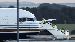 Members of the staff board a plane reported by British media to be first to transport migrants to Rwanda, at MOD Boscombe Down base in Wiltshire, Britain, June 14, 2022.