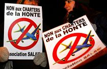Protestors, holding posters which read, "No to the charter flights of shame"