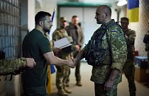 June 6, 2022, Ukrainian president Volodymyr Zelenskyy shakes hands with a Ukrainian serviceman during a visit to the frontline.