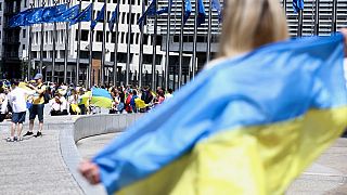 Protestors gather during a rally and take part in a human chain around the headquarters of the European Commission, to support Ukraine's application for EU candidacy status.