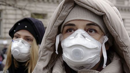 Women wearing face masks take part in a protest against air pollution, in Sarajevo, Bosnia, Monday, Jan. 20, 2020.